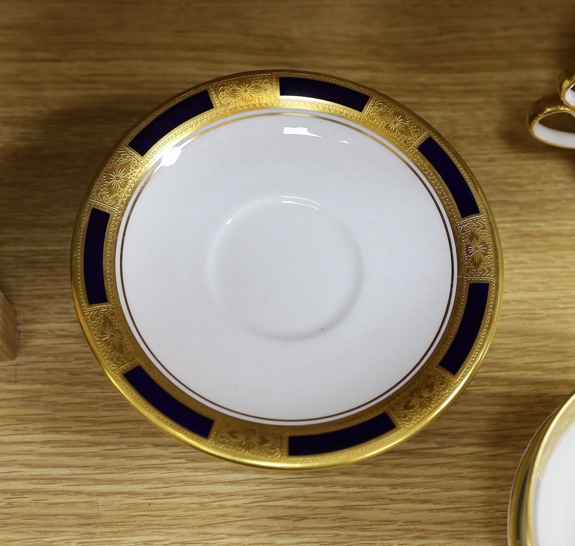 An Aynsley blue and gilt part dinner service